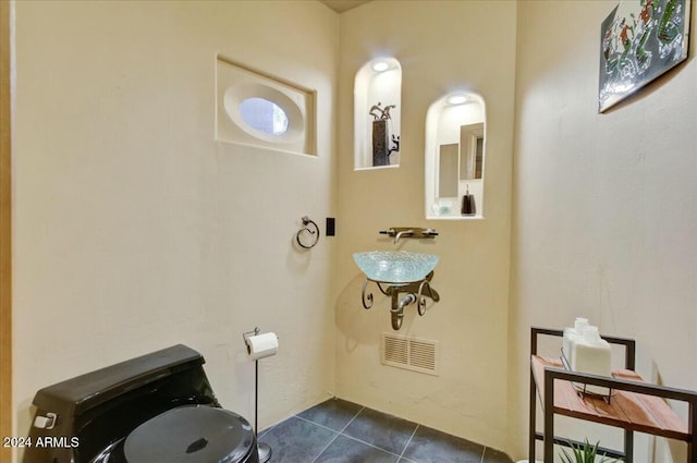 bathroom with tile patterned flooring and sink