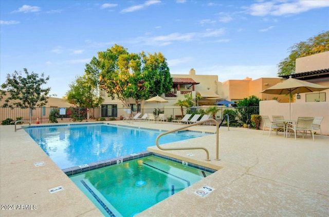 view of pool featuring a community hot tub and a patio