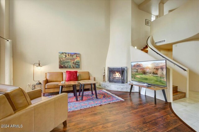 interior space featuring dark hardwood / wood-style floors, a fireplace, and a high ceiling