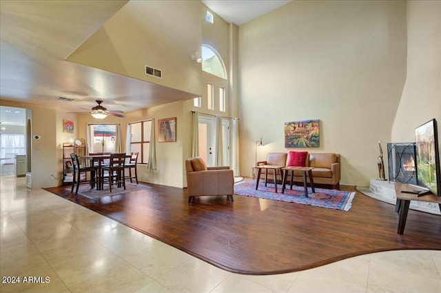 living room featuring ceiling fan and light hardwood / wood-style floors