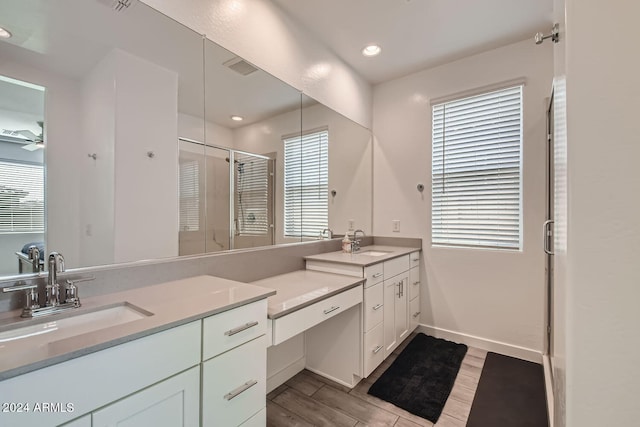 bathroom featuring vanity, plenty of natural light, an enclosed shower, and hardwood / wood-style flooring