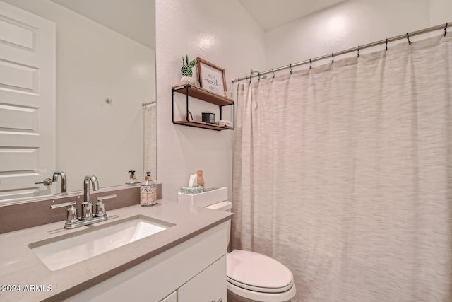 bathroom featuring a shower with shower curtain, vanity, and toilet