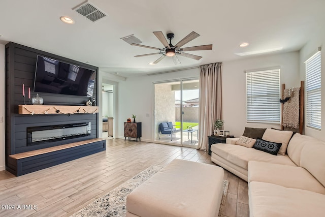 living room featuring light hardwood / wood-style floors and ceiling fan