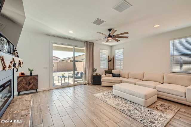 living room with ceiling fan and light hardwood / wood-style floors