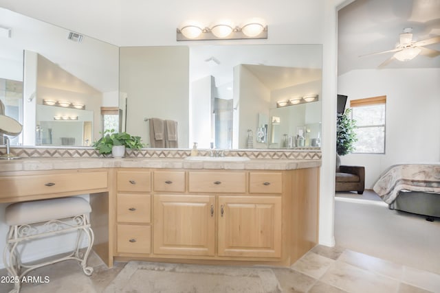 ensuite bathroom with visible vents, connected bathroom, vanity, and ceiling fan