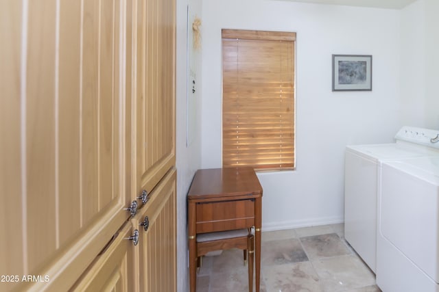 clothes washing area featuring laundry area, washer and clothes dryer, and baseboards