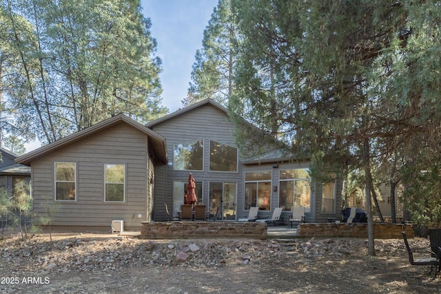 view of front of house featuring a sunroom and a patio