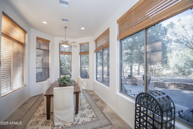 sunroom / solarium with ceiling fan and visible vents