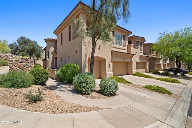 16420 N Thompson Peak Pkwy Unit 1002, Scottsdale, AZ 85260 - view of front of house featuring a garage, stucco siding, and driveway