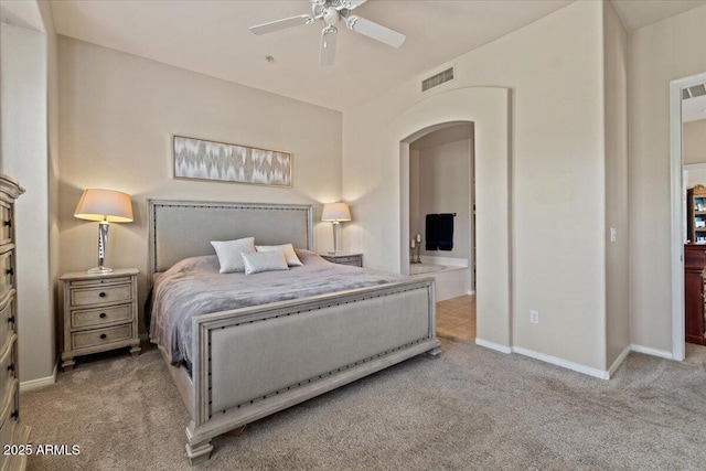 16420 N Thompson Peak Pkwy Unit 1002, Scottsdale, AZ 85260 - carpeted bedroom featuring arched walkways, baseboards, connected bathroom, and a ceiling fan