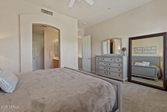 16420 N Thompson Peak Pkwy Unit 1002, Scottsdale, AZ 85260 - bedroom featuring carpet flooring, arched walkways, a ceiling fan, and ensuite bath