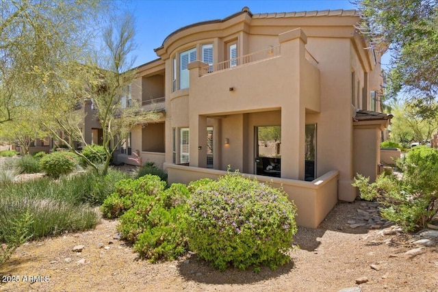 16420 N Thompson Peak Pkwy Unit 1002, Scottsdale, AZ 85260 - back of house with stucco siding and a balcony