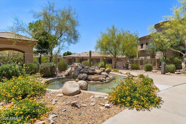 16420 N Thompson Peak Pkwy Unit 1002, Scottsdale, AZ 85260 - view of community featuring a small pond and fence