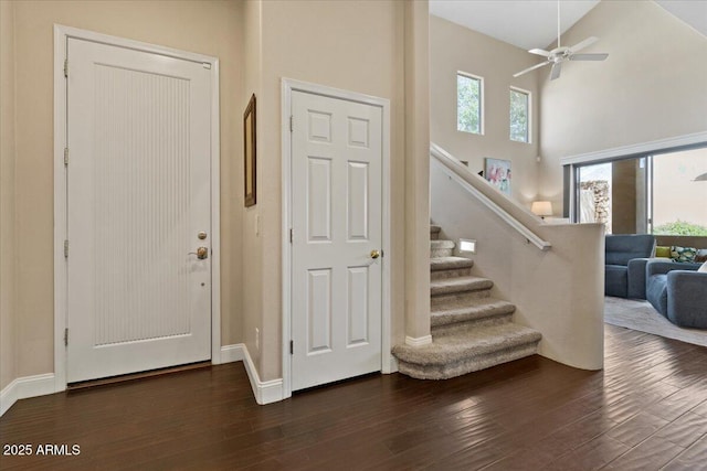 16420 N Thompson Peak Pkwy Unit 1002, Scottsdale, AZ 85260 - foyer entrance featuring dark wood-style floors, a high ceiling, ceiling fan, stairs, and baseboards