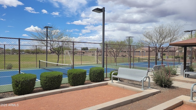 view of tennis court featuring fence