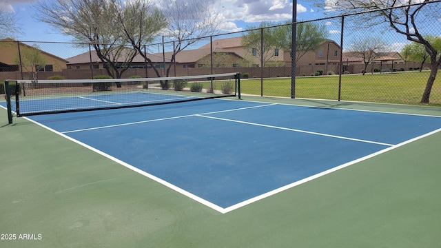 view of sport court with fence, a lawn, a residential view, and community basketball court