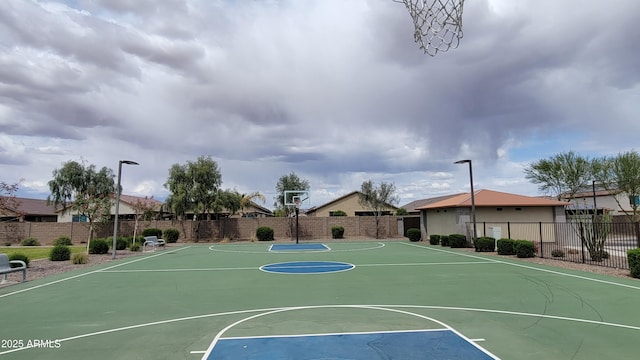 view of basketball court with fence, a residential view, and community basketball court