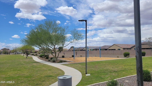 surrounding community with fence, playground community, a yard, and a residential view