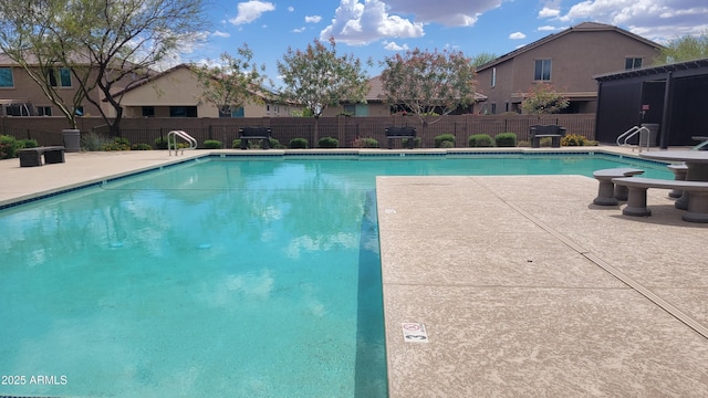 pool featuring fence and a patio area