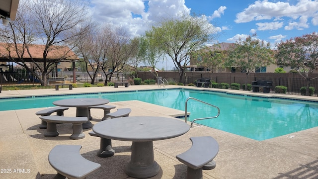 pool featuring fence and a patio area