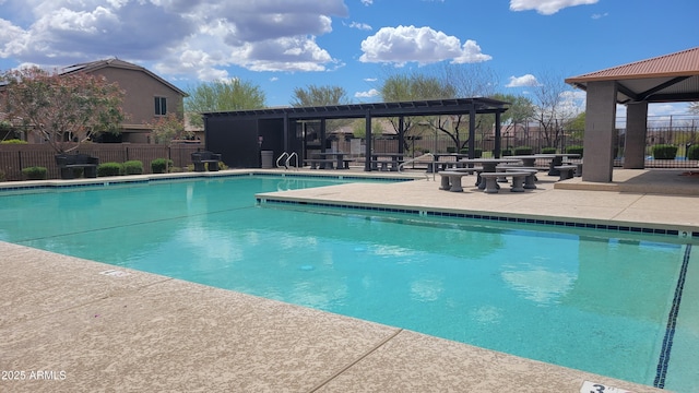 pool with fence, a gazebo, and a patio