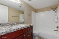 full bathroom with vanity, toilet, and washtub / shower combination