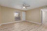 empty room featuring ceiling fan and light wood-type flooring