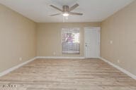 spare room featuring ceiling fan and light hardwood / wood-style flooring