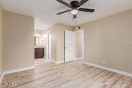 spare room featuring ceiling fan and light hardwood / wood-style flooring