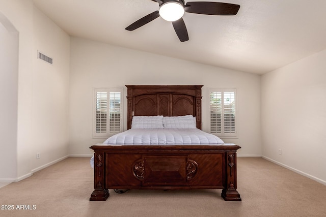 bedroom with baseboards, visible vents, lofted ceiling, and light carpet