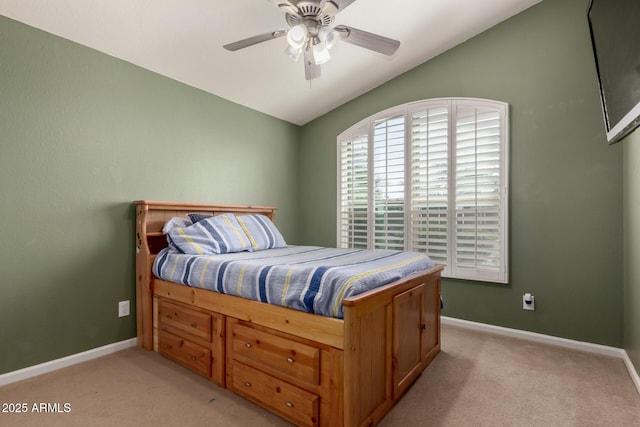 bedroom with baseboards, lofted ceiling, light colored carpet, and ceiling fan