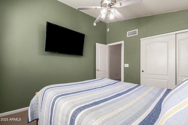 carpeted bedroom with visible vents, baseboards, ceiling fan, vaulted ceiling, and a closet