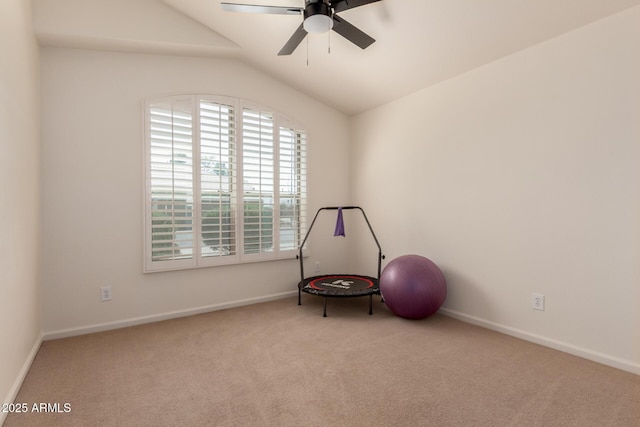 misc room with carpet flooring, baseboards, a ceiling fan, and vaulted ceiling