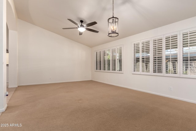 spare room with baseboards, lofted ceiling, carpet flooring, and ceiling fan with notable chandelier