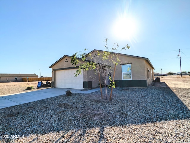 3760 N La Paz Dr, Eloy, AZ 85131 - view of front of house featuring driveway, an attached garage, and stucco siding