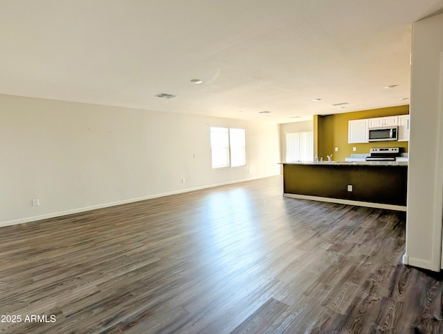 3760 N La Paz Dr, Eloy, AZ 85131 - unfurnished living room featuring baseboards, visible vents, and dark wood finished floors