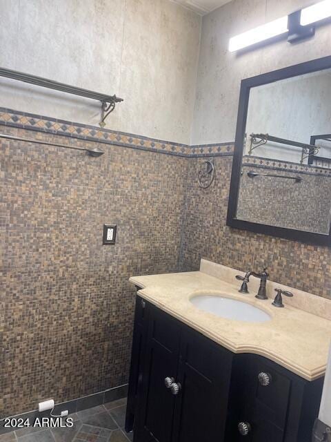 bathroom featuring vanity, tile patterned floors, and tile walls