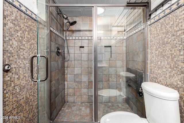 bathroom with toilet and walk in shower