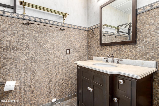 bathroom with tile patterned flooring, vanity, and tile walls