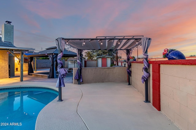 pool at dusk featuring a patio area