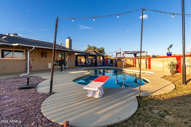 view of swimming pool with a gazebo, a diving board, a pergola, and a patio