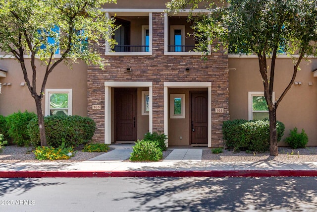 5550 N 16th St Unit 166, Phoenix, AZ 85016 - view of front of property featuring stone siding, stucco siding, and a balcony