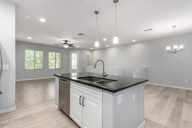 5550 N 16th St Unit 166, Phoenix, AZ 85016 - kitchen featuring open floor plan, dark countertops, stainless steel dishwasher, light wood-style flooring, and a ceiling fan