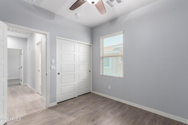 5550 N 16th St Unit 166, Phoenix, AZ 85016 - unfurnished bedroom with wood finished floors, a closet, and ceiling fan