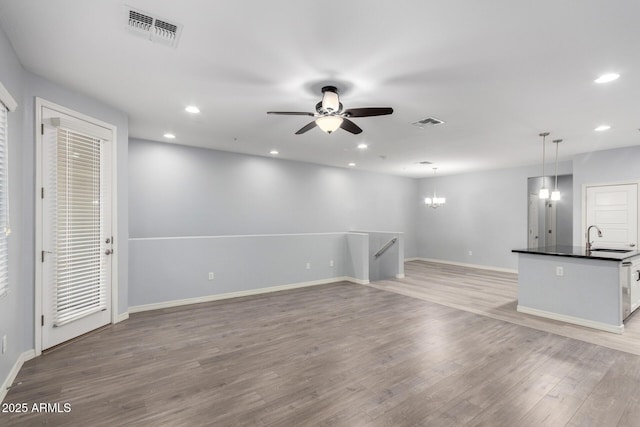 5550 N 16th St Unit 166, Phoenix, AZ 85016 - unfurnished living room with a ceiling fan, light wood finished floors, recessed lighting, and a chandelier
