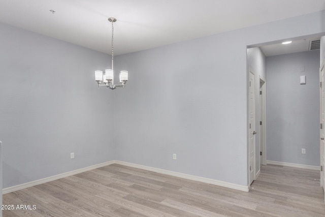 5550 N 16th St Unit 166, Phoenix, AZ 85016 - spare room featuring light wood-style floors and a chandelier
