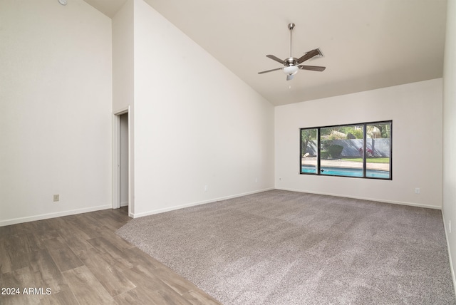 unfurnished living room featuring high vaulted ceiling, hardwood / wood-style floors, and ceiling fan