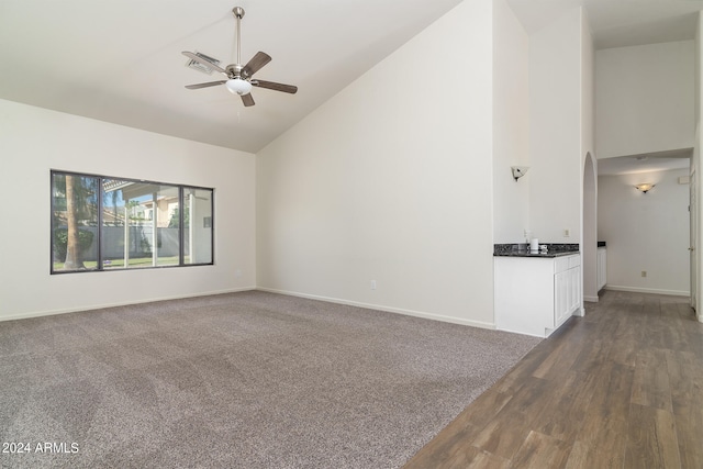 unfurnished living room featuring high vaulted ceiling, ceiling fan, and dark hardwood / wood-style floors