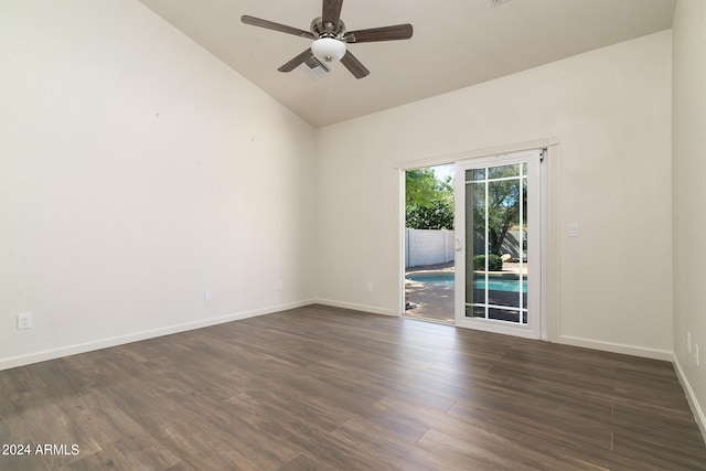 spare room featuring dark hardwood / wood-style flooring, lofted ceiling, and ceiling fan