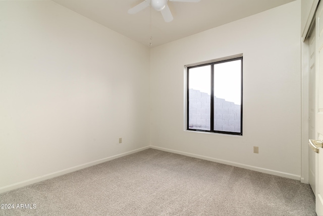 carpeted empty room featuring ceiling fan